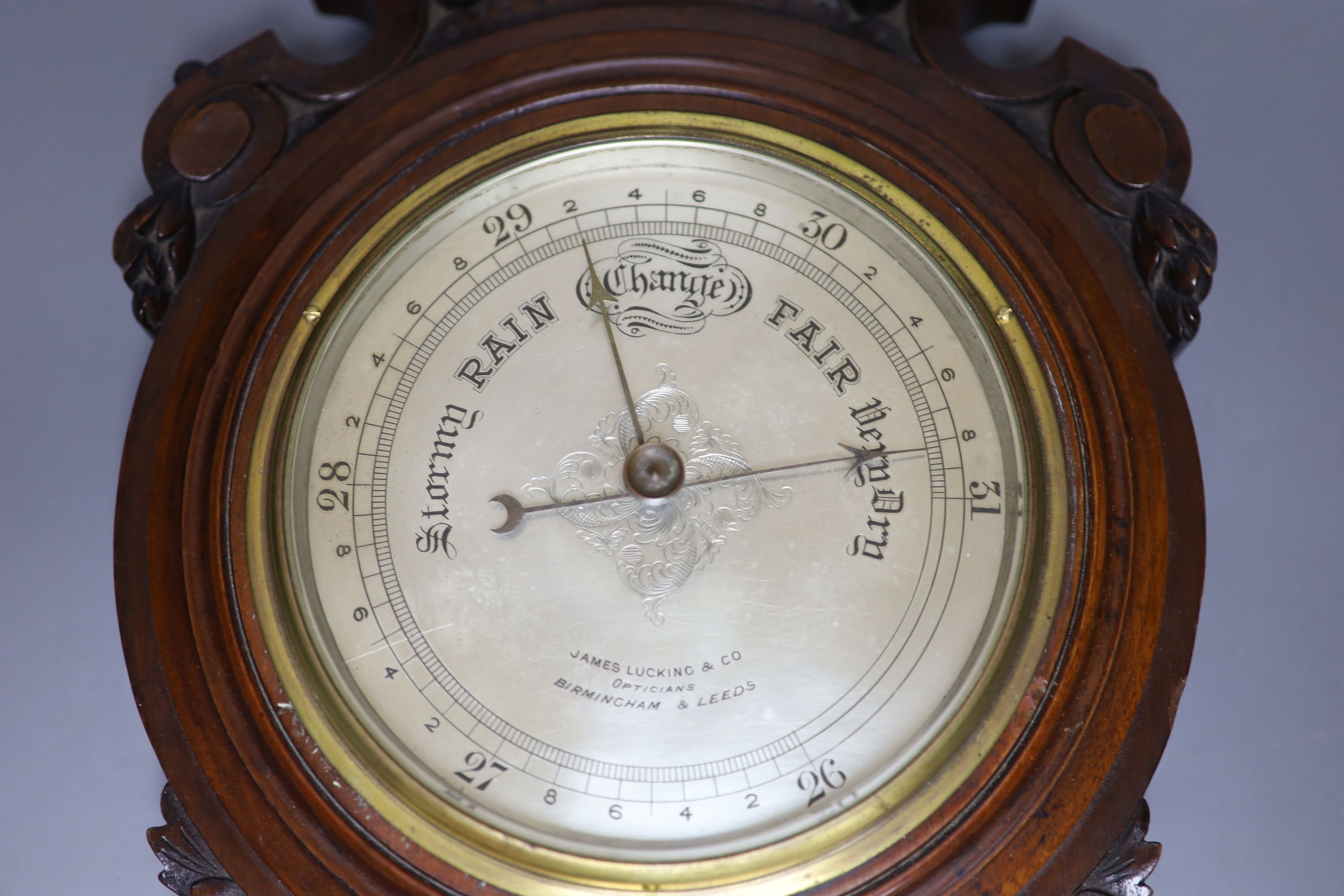 James Lucking & Co. A carved mahogany aneroid barometer, length 46cm